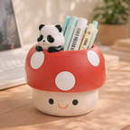 Cute mushroom-shaped pen holder with a panda figure on a wooden surface.
