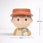 Cute Germiant ceramic planter of child with brown hat, 9.5 cm high, 8 cm wide
