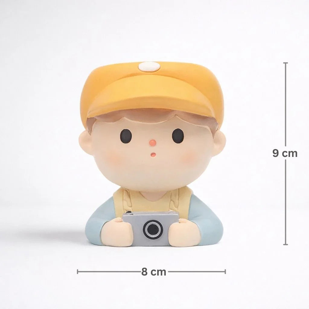 Cute boy figurine in yellow cap holding camera, 9 cm tall, Germiant home decor.