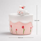 Ceramic container with a rabbit figurine and floral design, featuring measurements on a light gray background.