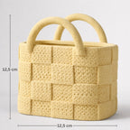 Yellow woven basket with handles and dimensions on a light gray background