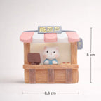Miniature bear figurine in a candy shop stall with pink awning, 8x8.5 cm, Germiant