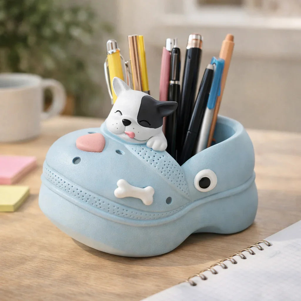 Cute blue shoe-shaped pen holder with dog figurine and pens on desk, Germiant decor.