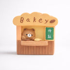 Cute bear figurine at bakery stall with bread, Germiant store decor