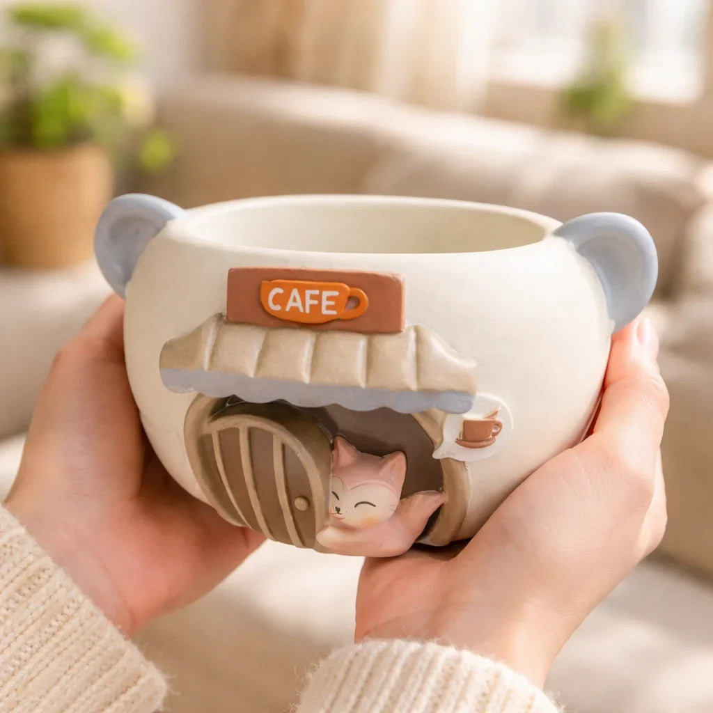 Cute ceramic cat cafe mug with 3D kitten design held in hands, Germiant aesthetic.