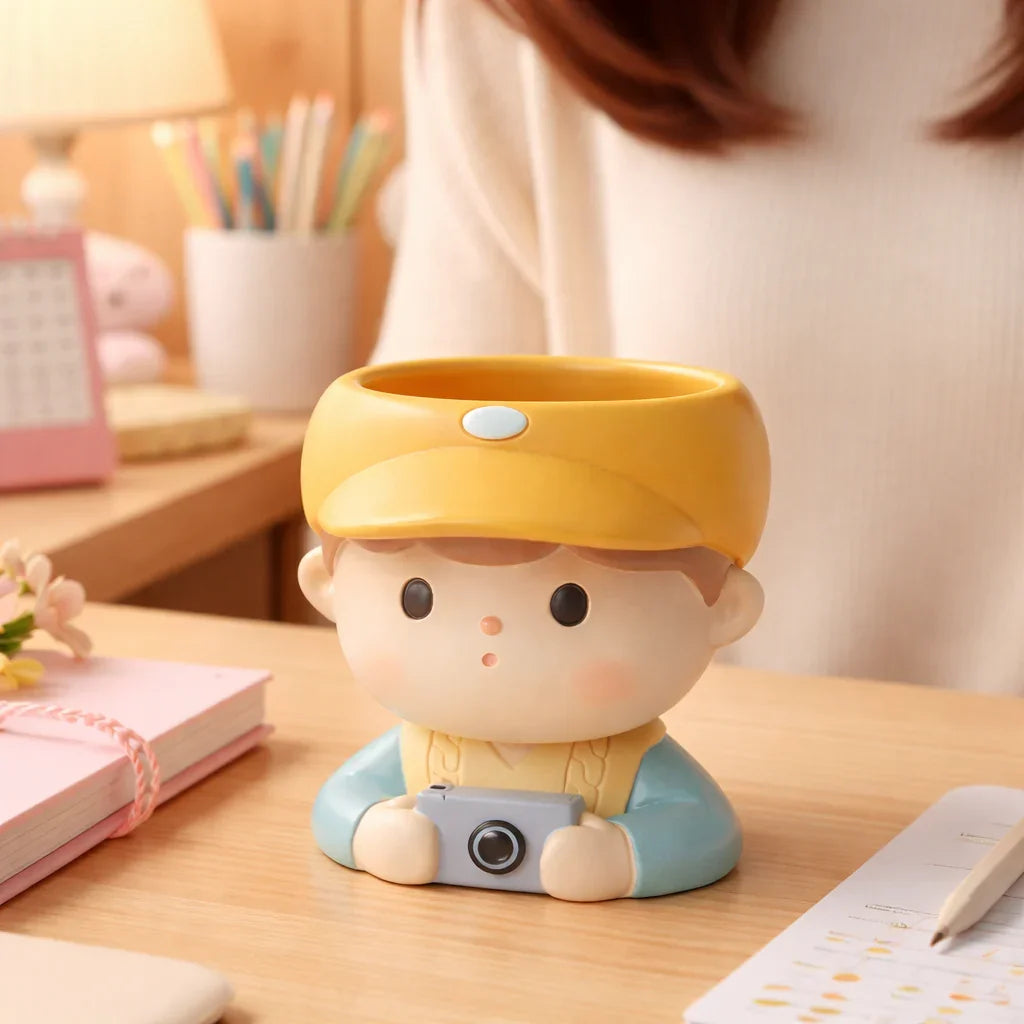 Cute boy planter pot with yellow hat and camera on wooden desk, Germiant decor