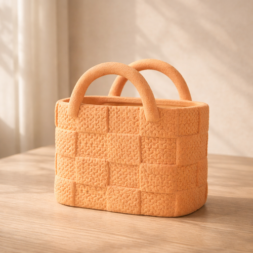 Orange woven basket with handles on a wooden surface