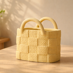 Yellow woven basket with handles on a wooden surface