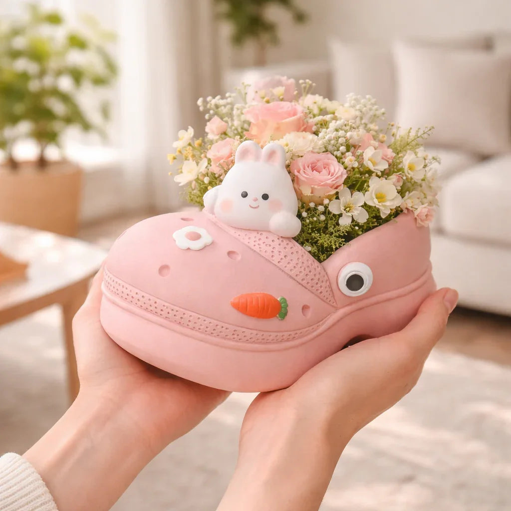 Cute pink shoe planter with bunny, carrot decoration, and pastel flowers, held in hands