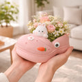 Cute pink shoe planter with bunny, carrot decoration, and pastel flowers, held in hands