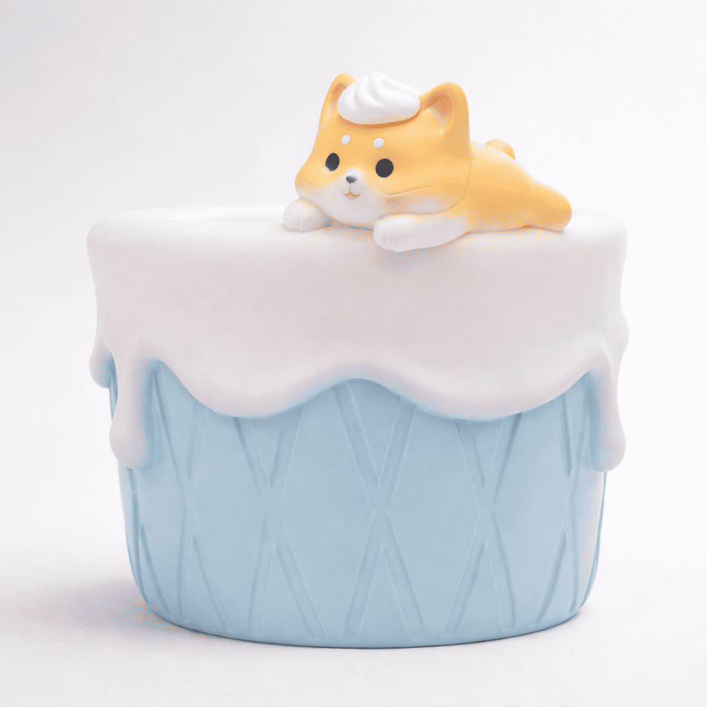 Cute dog figurine on top of a light blue ice cream cone with white cream on a white background