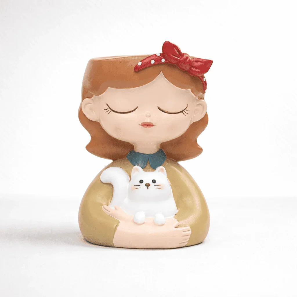 Decorative figurine of a girl holding a cat on a white background