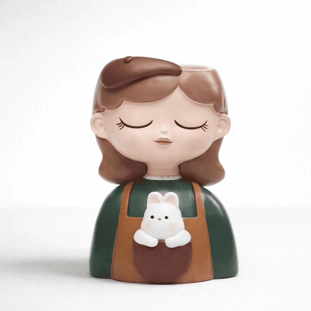 Decorative figurine of a girl with a bunny in her apron pocket on a white background