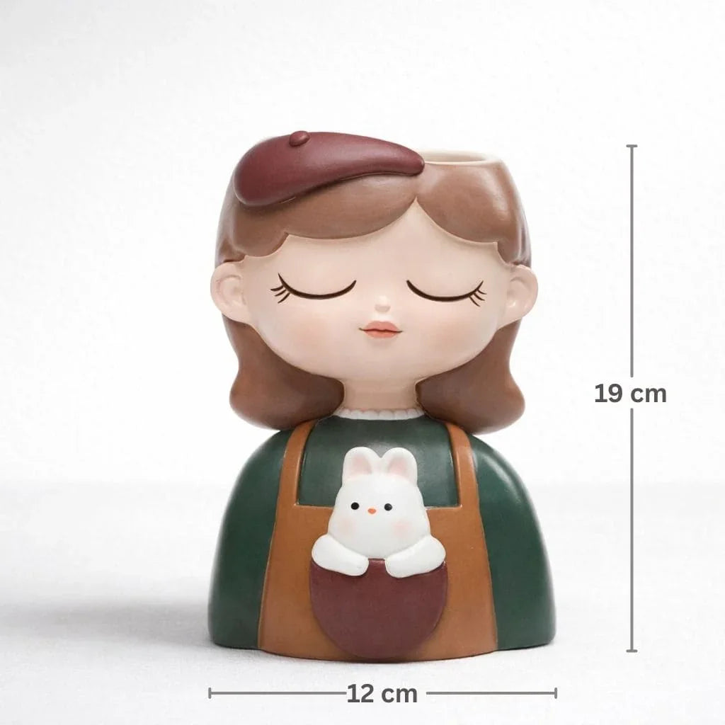 Decorative figurine of a girl with a cat in her apron, with measurements indicated.
