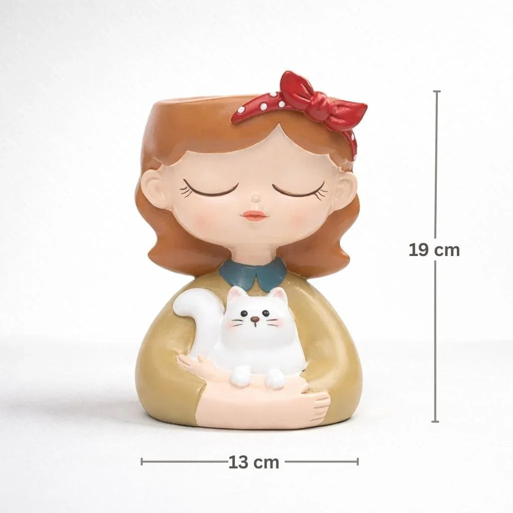 Decorative figurine of a girl with a white cat, wearing a red bow, with measurements indicated.