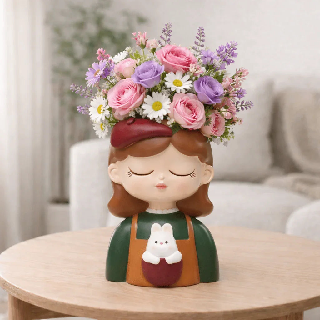 Decorative vase shaped like a girl with flowers on her head, sitting on a table.