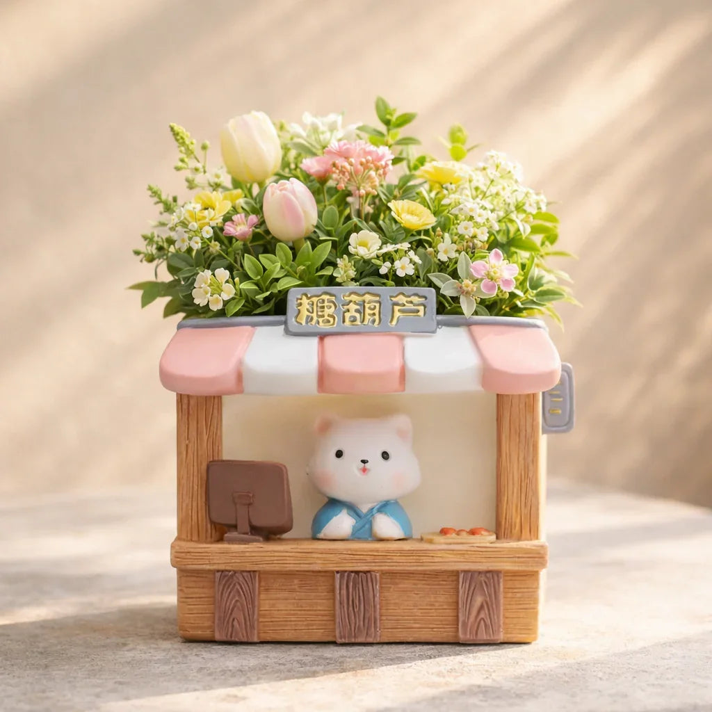 Cute bear figurine at small market stall planter with pink flowers and greenery, Germiant decor