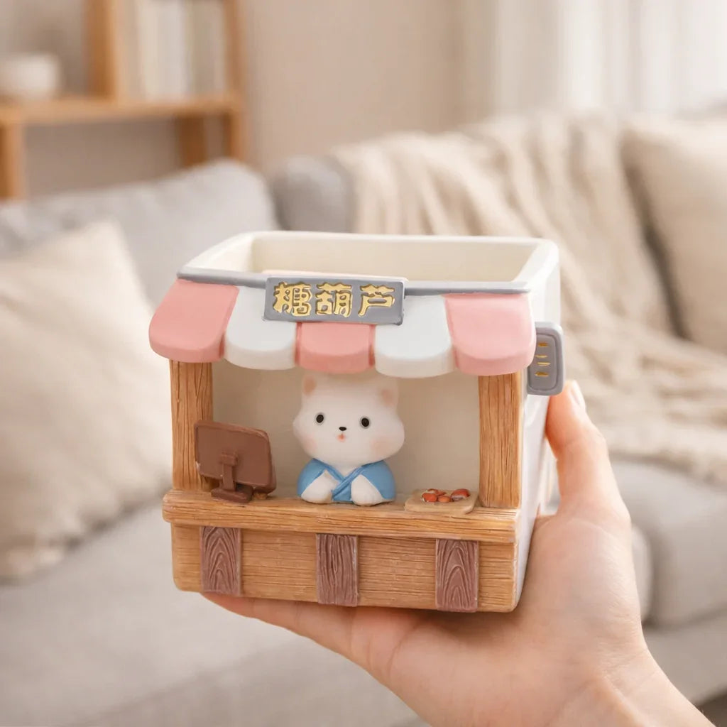 Cute bear-shaped ceramic planter with a market stall design, held in a cozy living room