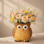Owl-shaped vase with flowers on a wooden surface