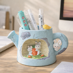 Cute blue watering can pen holder with bunny and carrot design, desk organizer on wooden table