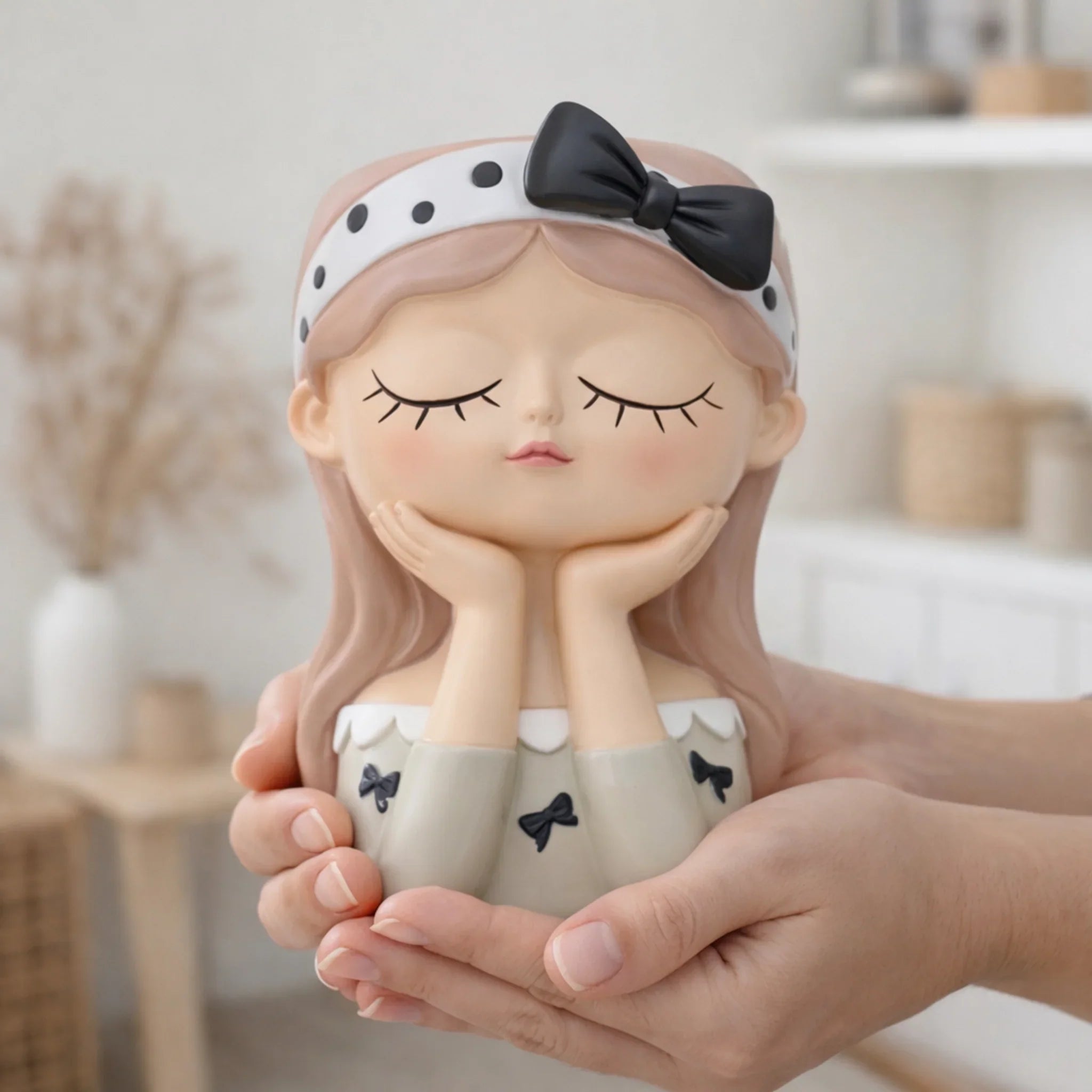 Hand holding cute girl figurine with closed eyes, polka dot headband and bow, Germiant decor