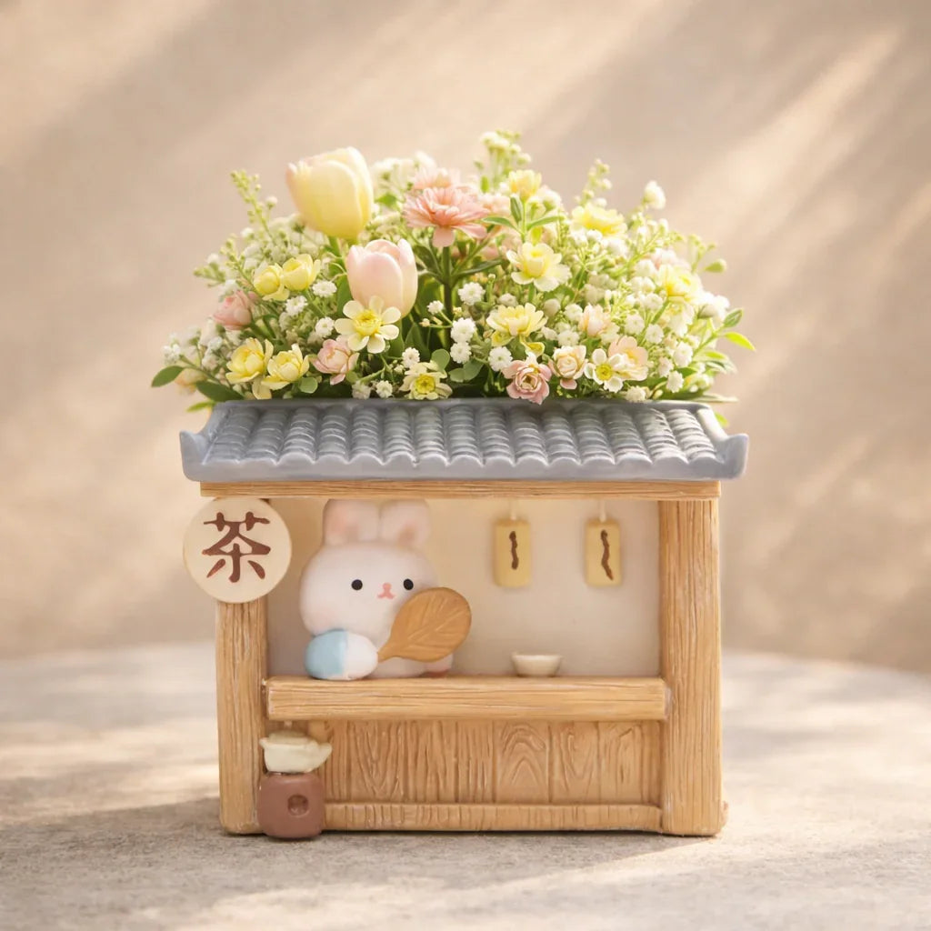 Cute bunny tea shop planter with pastel flowers, floral decor from Germiant