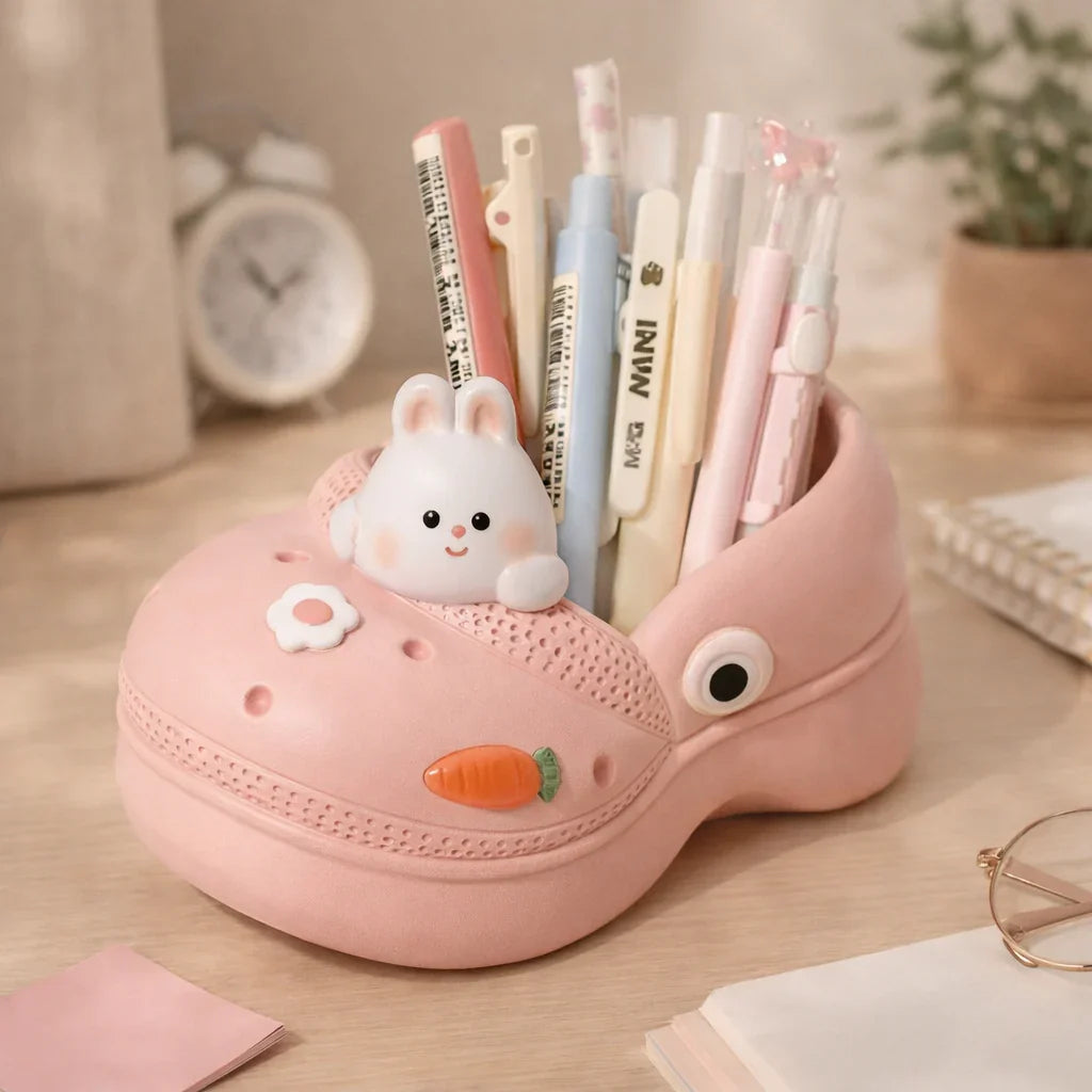 Cute pink shoe pen holder with bunny decor, pens, and carrot detail on desk, Germiant