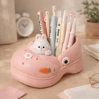 Cute pink shoe pen holder with bunny decor, pens, and carrot detail on desk, Germiant